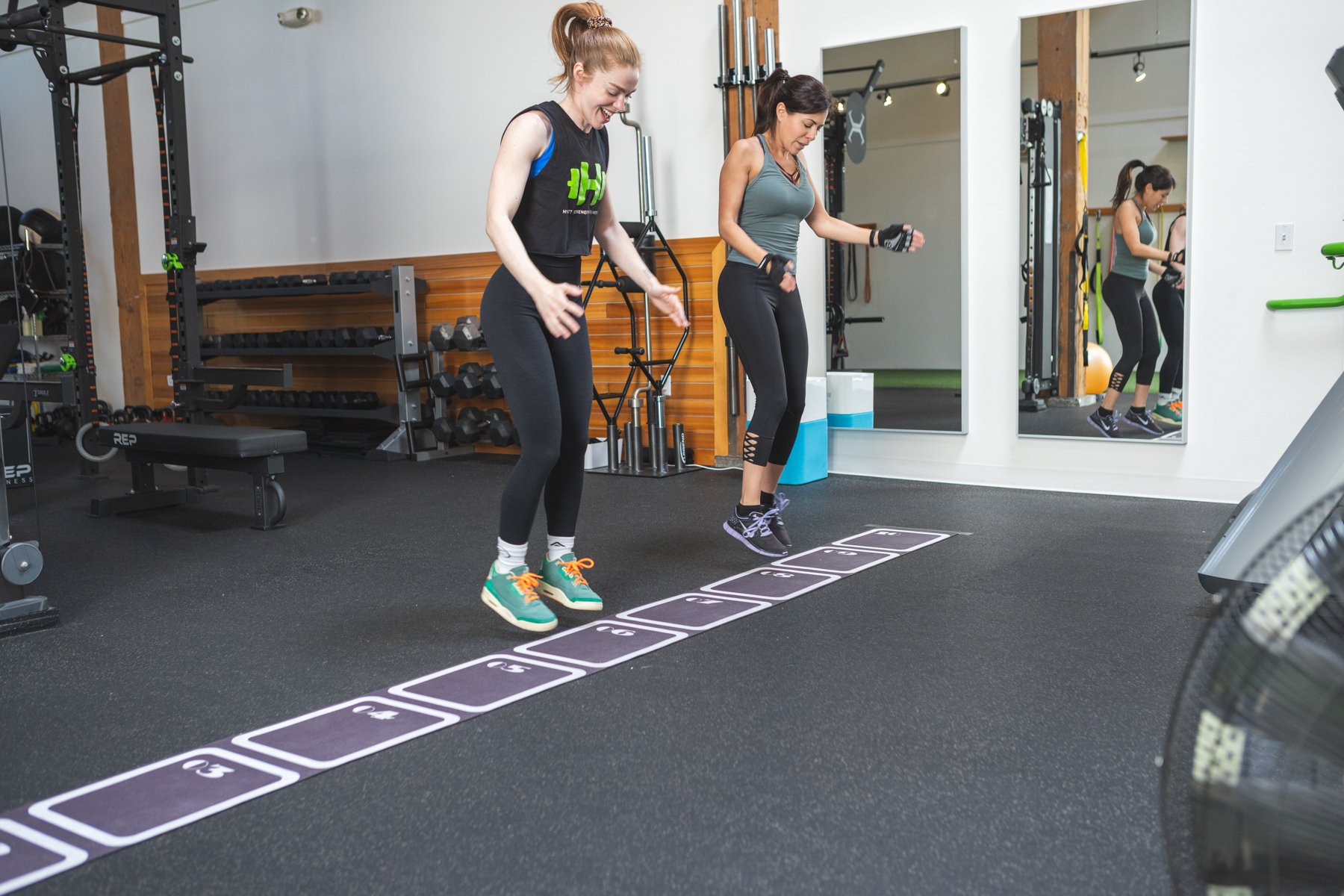 Female trainer and client training like athletes at Hyatt Strength + Wellness